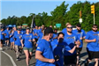 Group of runners wearing blue shirts