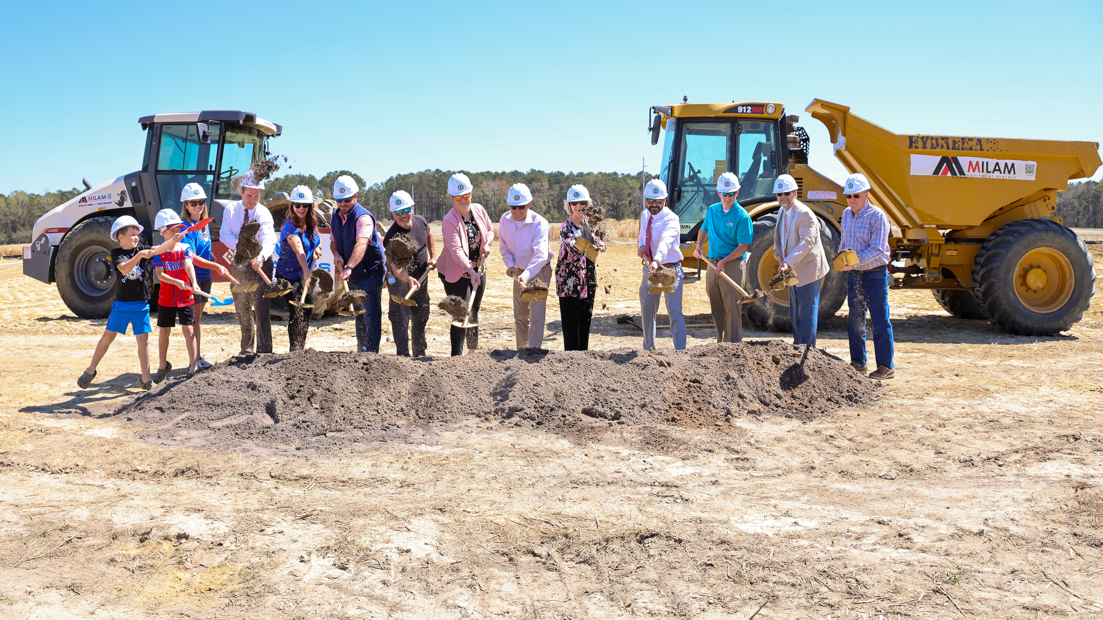 groundbreaking ceremony people digging dirt